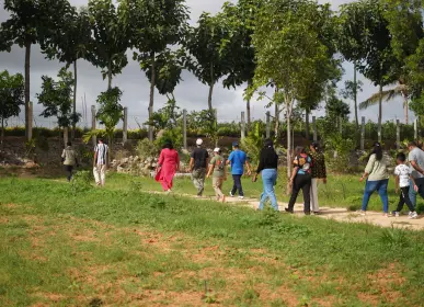 Home owners walking through the green surroundings at farmland