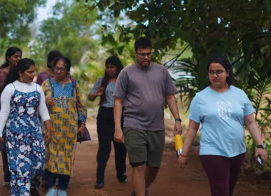 Group walking through the farm during a site visit at Girivanam near Kanakapura