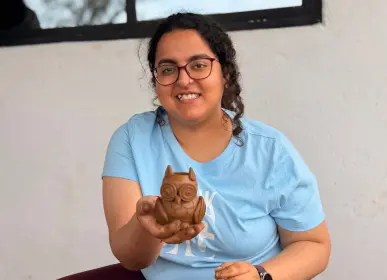 Visitor taking part in a pottery activity during a farm experience at Girivanam