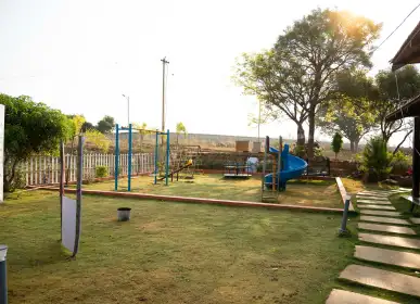 Kids’ play area surrounded by landscaped greenery at H2O Farms