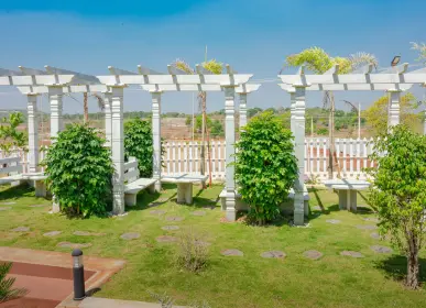 Landscaped pergola and green community space at farm