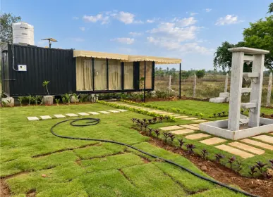 Landscaped garden area with a farm stay unit at Sangam Farms