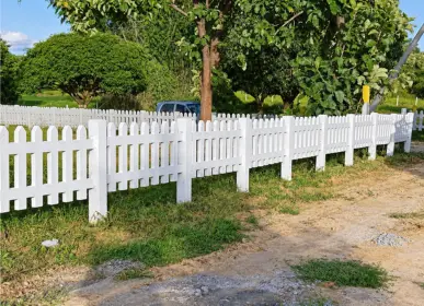White picket fencing along a plot at Sangam Farms