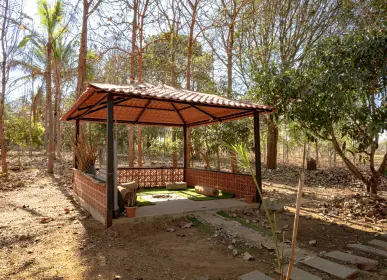 Gazebo set among mature trees at Vasudha Kalpatharu
